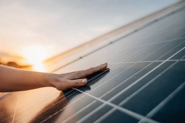 hand on solar panel